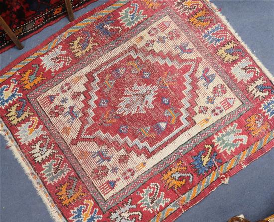 A Caucasian small red medallion rug 105cm x 95cm